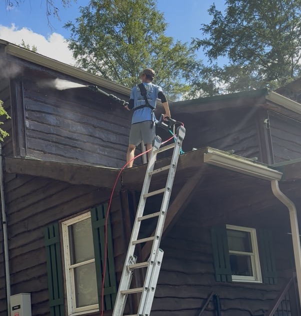 Clean 1's team pressure washing a home exterior